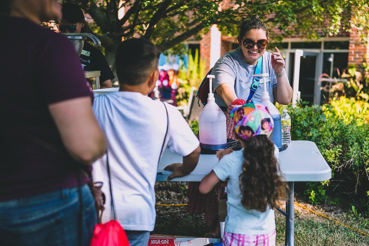 children pumping syrup onto their sno cones at a recent Doane event